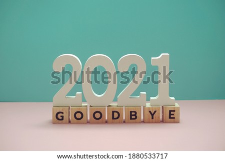 Goodbye 2021 alphabet letter on blue and pink background