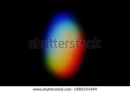 Coloured optical lens flare on black background.