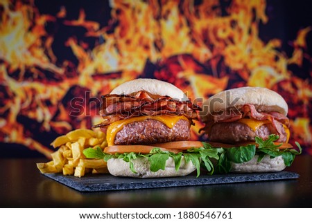 hamburgers with fries with fire background