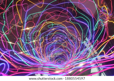 Luminescent abstract background. Neon lines. Neon art. Backdrop with neon mixed lines. Neon futuristic fantasy. Christmas, New Year lights. Luminosity pattern. Holiday light. Geometric modern ornament Royalty-Free Stock Photo #1880554597