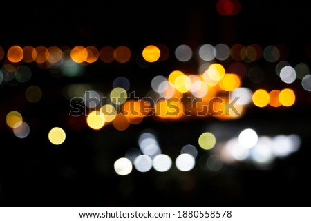 light night city bokeh abstract background glittering stars on bokeh. Orange bokeh in the bottom of the picture. Has a black background