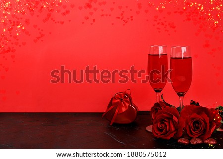 Greeting card for Valentine's Day or Women's Day, banner, hearts, roses and wine on a red background. Happy holiday, congratulation, birthday, wedding, selective focus
