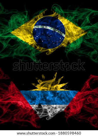 Brazil, Brazilian vs Antigua and Barbuda, Antiguan and Barbudan smoky mystic flags placed side by side. Thick colored silky abstract smoke flags.