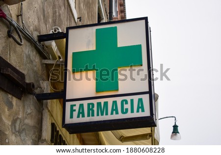 Glowing pixel cross of LED lamps on black background. Green cross symbol of health, medicine, self-care. Stock photo with empty space for text and design.
Pharmacy, Farmacia sign in Italy