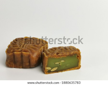 Selective focus photo with noise effect of square shape moon cake isolated on white background.