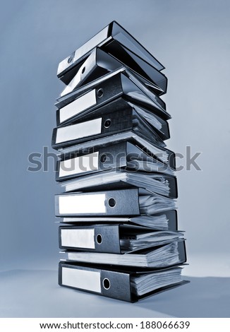 A tall stack of ring binders.