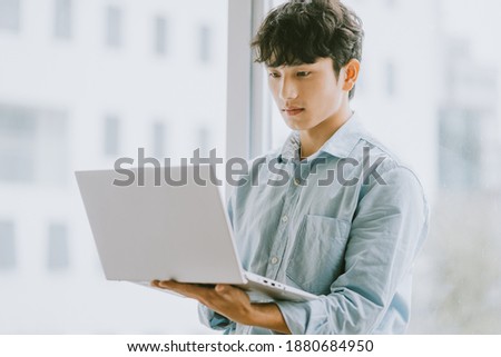 Asian businessman is using laptop to work by window
 Royalty-Free Stock Photo #1880684950