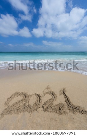 Numbers 2021 on beach - concept holiday background

