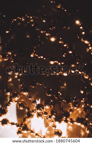 Golden christmas garland, abstract background and texture beads close up. Holiday concept	