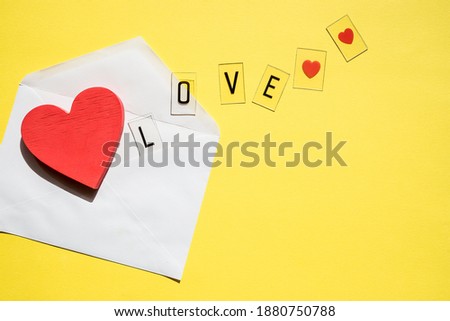 Opened envelope and red heart.Creative design for packaging, blogger.Happy birthday, wedding, Valentine's day concept of greetings. Copy space.