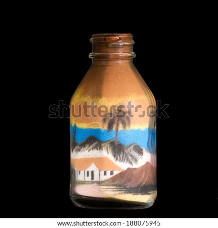 house made of sand inside a sealed bottle