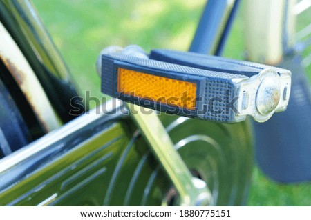 A selective focus shot of a bicycle pedal