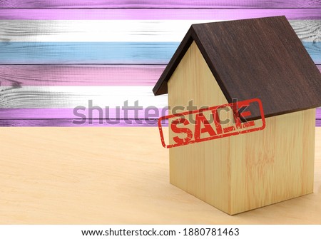 The concept sale of apartments, of real estate mortgages, citizenship and accommodation, as well as investment in a future home. Bigender pride flag on wooden background.