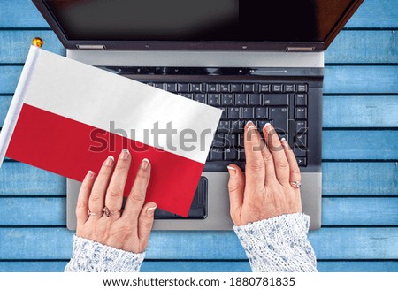 woman hands and flag of Poland on computer, laptop keyboard 