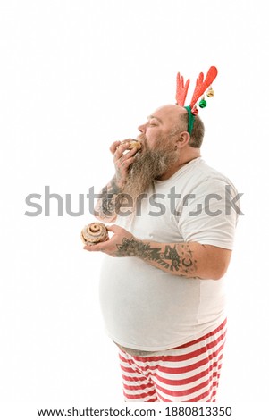 Emotional fat funny and tattooed man with food isolated on a white background