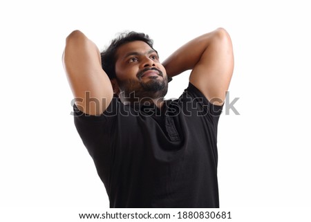 Indian young men model in black T-shirt on white background looking towards sky in relaxing pose at studio soot  