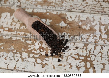 black pepper on a white old board. top view