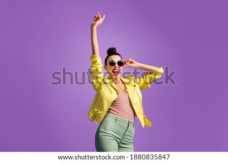 Photo of crazy youth lady touch hands sunglass raise index finger up isolated over purple color background