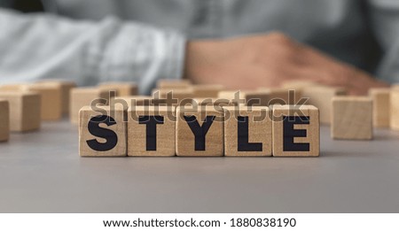 The word STYLE made from wooden cubes. Conceptual photo. Selective focus. Shallow depth of field on the cubes
