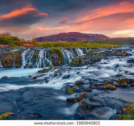 Beautiful summer scenery of Bruarfoss Waterfall, secluded spot with cascading blue waters. Magnificent sunset in Iceland, Europe. Landscape photography.
