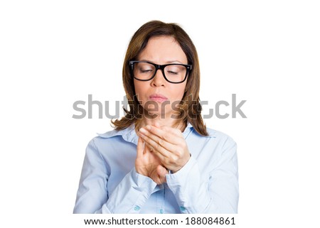 Closeup portrait, perfectionist mature woman in black glasses, obsessive compulsive nerdy, agitated, anxiously staring at fingernails, making sure they clean isolated white background. Face expression