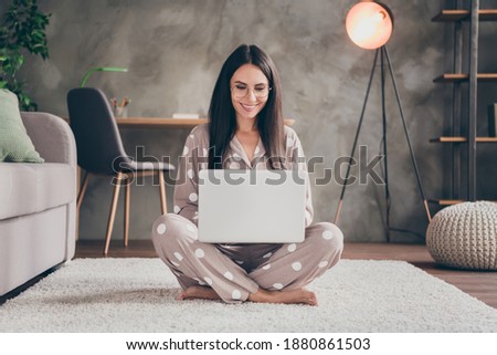 Photo of nice sweet girl sit on carpet type laptop wear spectacles pijama at home