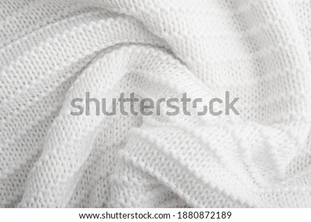 Close up of white knitted textured background. Trendy color.