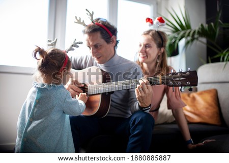 Family singing carols at home in Christmas