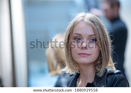 Close up portrait of a pensive and daydreaming beautiful blonde woman. Selective focus Royalty-Free Stock Photo #1880929558