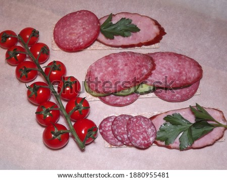 sandwich with different types of sausage and vegetables, quick snack. High quality photo