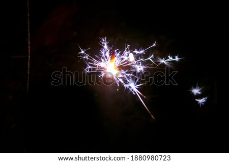 Firework, sparklers and bokeh lights on dark blue background