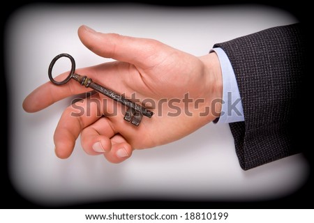 business man hold key of success in his hand