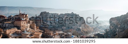 Turkey, Urgup - Panarama of the city in the morning from the mountain. View of the old stone mansions located in the gorge Royalty-Free Stock Photo #1881039295