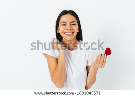 Beautiful young woman getting a marriage proposal on a white background