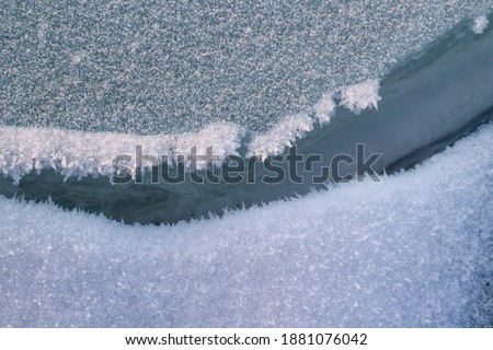 Cracked River Ice and Frost Close-up Winter Snow Surface Background 