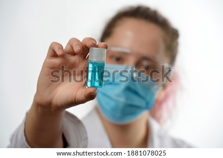 
chemical girl looks at a can of blue product