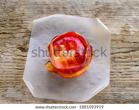 peeled tangerine wrapped in Apple peel