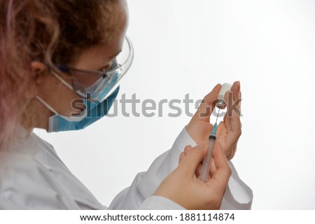 
Doctor or scientist hand with vaccine vial and syringe with needle
