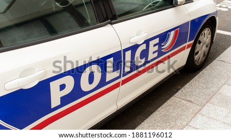 Close-up shot of the word "Police" written on the side of a patrol vehicle of the french national police, France