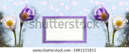 Widescreen background with the first spring snowdrops, snow and heart-shaped bokeh. Photo frame with blank paper for greeting text