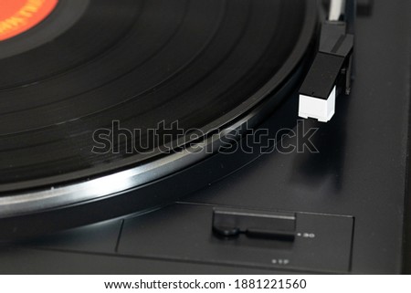 Vinyl plate and needle. Vintage record player for vinyl, black platter and size knob. Turntable vinyl and needle