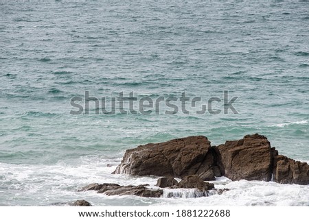Rocks and cliffs at stormy sea in Cornwall