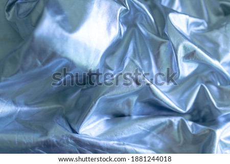 Abstract futuristic looking blue texture background.  Shiny silky sheet. Satin linens