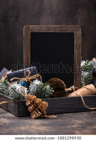 Christmas festive composition with gift boxes, craft tree toy and chalkboard