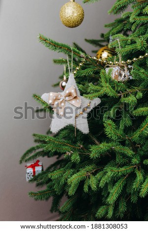 Diy Christmas ornaments. Festive star with ribbon bow on christmas tree. Handmade christmas decor
