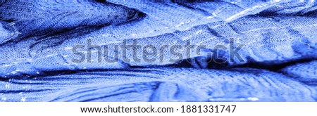Blue silk fabric. Shirred fabrics, fabrics with parallel or diagonal folds with serrated folds.