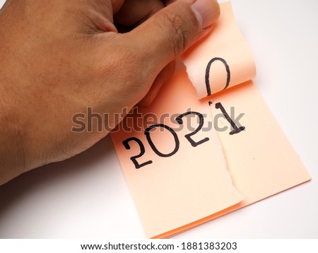 Picture of sticky note with 2020 number which symbolizes end of year 2020 and welcoming new year 2021