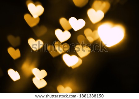 Festive overlay effect. Blurred golden heart bokeh festive glitter background. Christmas, New Year and Valentine's day design