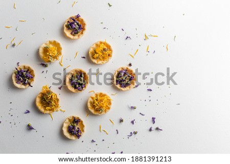 Tartlets with dried flower petals. Calendula homeopathic. Mallow dried flowers on white background with Calendula and blue cornflower bluebottle with copy space. Cornflower petals. 