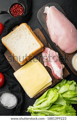 Club sandwich ingredients, on black background, top view